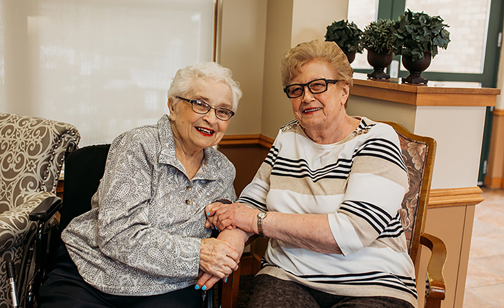 Two friends hold hands at Auburn Courts in Chaska