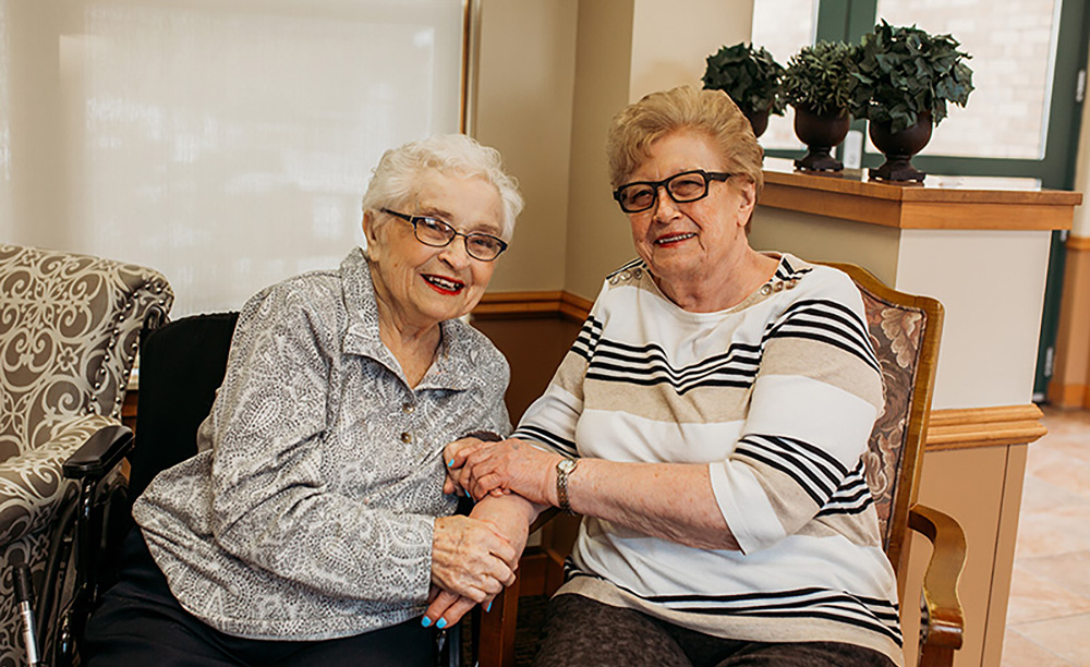 Two friends hold hands at Auburn Courts in Chaska